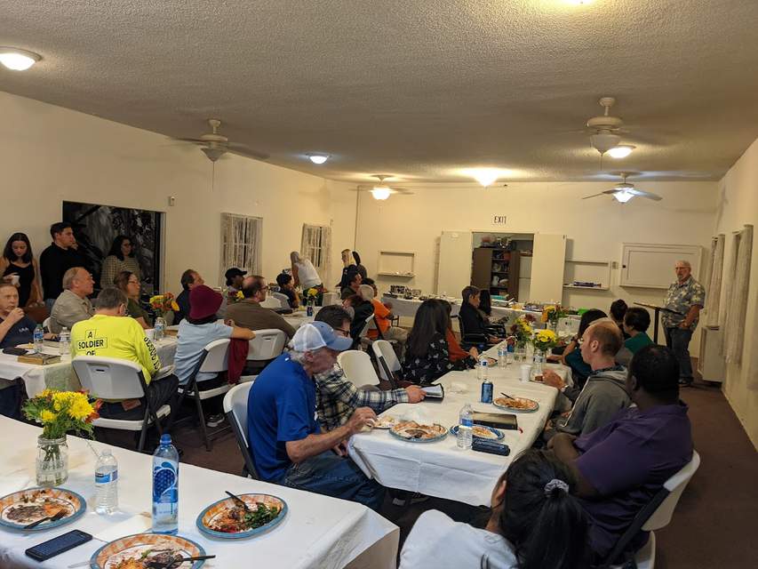 Pastor Miller teaching at Thanksgiving fellowship dinner.