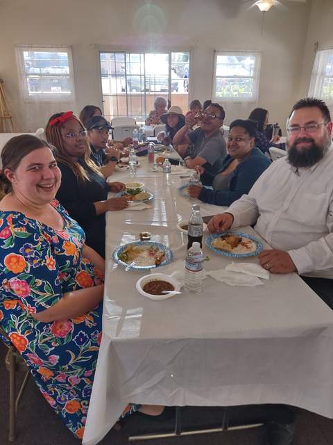 Pastor Rick and his wife Amy (foreground) enjoying a fellowship meal with the congregation.